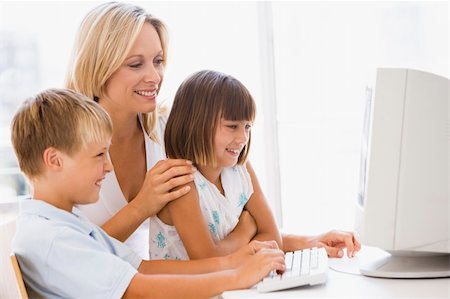 simsearch:400-04044108,k - Woman and two young children in home office with computer smilin Stock Photo - Budget Royalty-Free & Subscription, Code: 400-04044066