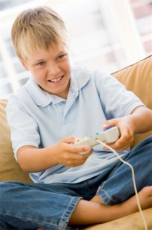 simsearch:400-04200290,k - Young boy in living room with video game controller smiling Stock Photo - Budget Royalty-Free & Subscription, Code: 400-04044062