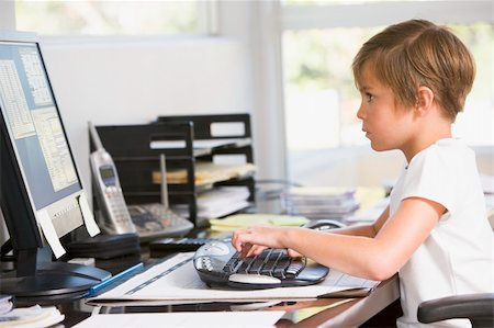 simsearch:400-04044137,k - Young boy in home office with computer typing Stock Photo - Budget Royalty-Free & Subscription, Code: 400-04044087