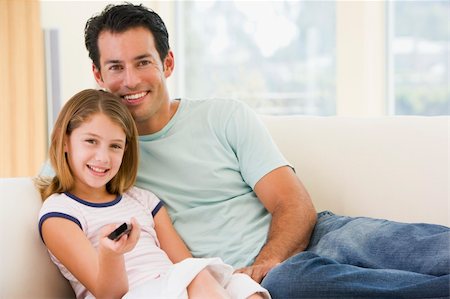 simsearch:400-04045202,k - Man and young girl in living room with remote control smiling Stock Photo - Budget Royalty-Free & Subscription, Code: 400-04044082