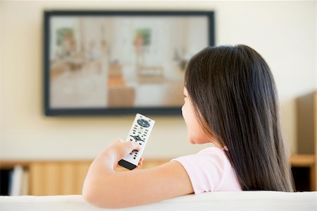 simsearch:400-04045202,k - Young girl in living room with flat screen television and remote Stock Photo - Budget Royalty-Free & Subscription, Code: 400-04044093