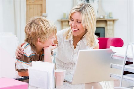 simsearch:400-04044122,k - Woman and young boy in home office with laptop smiling Stock Photo - Budget Royalty-Free & Subscription, Code: 400-04044112