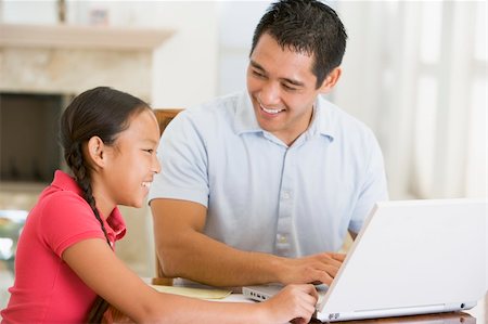 Man and young girl with laptop in dining room smiling Stock Photo - Budget Royalty-Free & Subscription, Code: 400-04044126