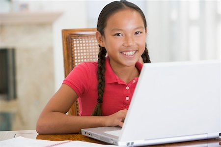 simsearch:400-04044137,k - Young girl with laptop in dining room smiling Stock Photo - Budget Royalty-Free & Subscription, Code: 400-04044129