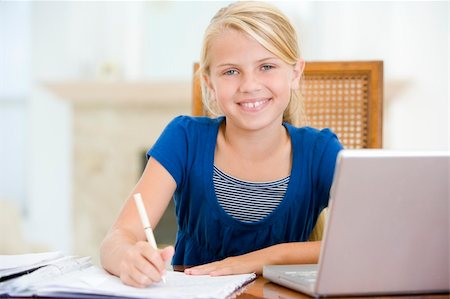 simsearch:400-04044137,k - Young girl with laptop doing homework in dining room smiling Stock Photo - Budget Royalty-Free & Subscription, Code: 400-04044136