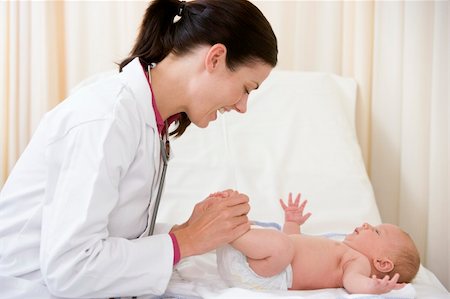 simsearch:400-08935984,k - Doctor giving checkup to baby in exam room smiling Stock Photo - Budget Royalty-Free & Subscription, Code: 400-04044304