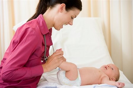 simsearch:400-08935984,k - Doctor giving checkup to baby in exam room smiling Stock Photo - Budget Royalty-Free & Subscription, Code: 400-04044306