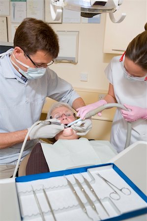 surgery tray - Dentist and assistant in exam room with woman in chair Stock Photo - Budget Royalty-Free & Subscription, Code: 400-04044355