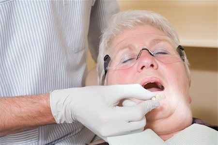 dentistry tray - Dentist in exam room fitting dentures on woman in chair Stock Photo - Budget Royalty-Free & Subscription, Code: 400-04044356