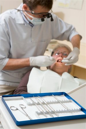 dentist tray - Dentist in exam room with woman in chair Stock Photo - Budget Royalty-Free & Subscription, Code: 400-04044351
