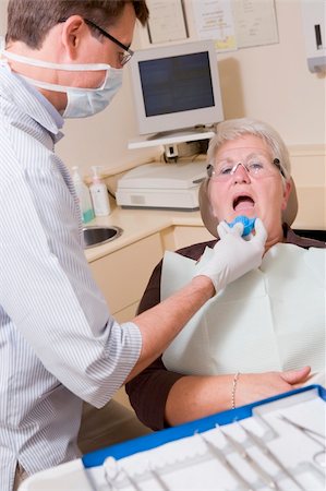 dentist tray - Dentist in exam room with woman in chair Stock Photo - Budget Royalty-Free & Subscription, Code: 400-04044353