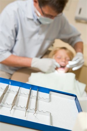 surgery tray - Dentist in exam room with young boy in chair Stock Photo - Budget Royalty-Free & Subscription, Code: 400-04044378