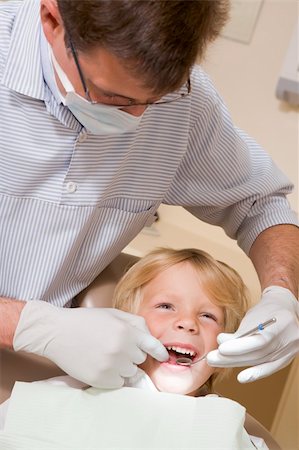 smile as mask for boy - Dentist in exam room with young boy in chair Stock Photo - Budget Royalty-Free & Subscription, Code: 400-04044379