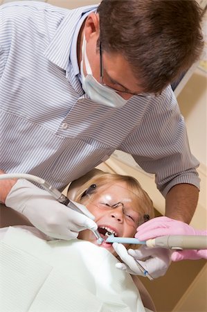 smile as mask for boy - Dentist in exam room with young boy in chair Stock Photo - Budget Royalty-Free & Subscription, Code: 400-04044380
