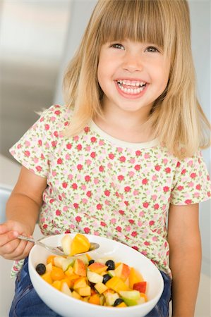 simsearch:400-04044645,k - Young girl eating a bowl of fruit at home Photographie de stock - Aubaine LD & Abonnement, Code: 400-04044652