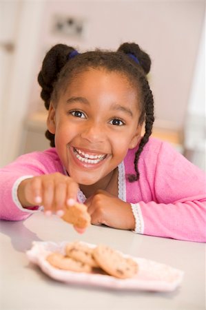 simsearch:640-02772614,k - Girl eating cookies at home Stock Photo - Budget Royalty-Free & Subscription, Code: 400-04044669