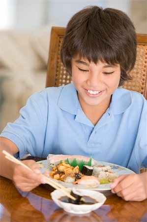 simsearch:400-04044714,k - Young boy in dining room eating chinese food smiling Stock Photo - Budget Royalty-Free & Subscription, Code: 400-04044688