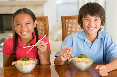 simsearch:400-04044761,k - Two young children eating Chinese food in dining room smiling. Foto de stock - Super Valor sin royalties y Suscripción, Código: 400-04044680