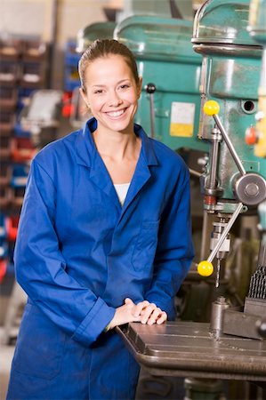 female factory worker looking at camera - Machinist working on machine Stock Photo - Budget Royalty-Free & Subscription, Code: 400-04045055