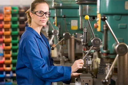 female factory worker looking at camera - Machinist working on machine Stock Photo - Budget Royalty-Free & Subscription, Code: 400-04045061