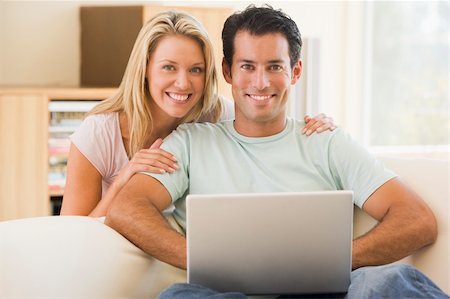 simsearch:400-04044137,k - Couple in living room using laptop smiling Stock Photo - Budget Royalty-Free & Subscription, Code: 400-04045109