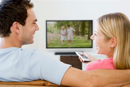 simsearch:400-04046300,k - Couple in living room watching television smiling Stock Photo - Budget Royalty-Free & Subscription, Code: 400-04045163