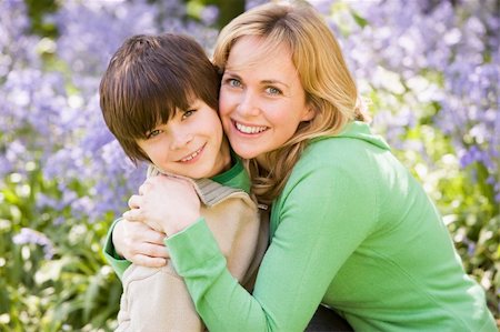 simsearch:400-05686748,k - Mother and son outdoors embracing and smiling Fotografie stock - Microstock e Abbonamento, Codice: 400-04045307