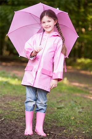 Young girl outdoors with umbrella smiling Stock Photo - Budget Royalty-Free & Subscription, Code: 400-04045365