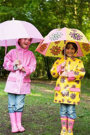 Two sisters outdoors in rain with umbrellas smiling Stock Photo - Budget Royalty-Free & Subscription, Code: 400-04045368