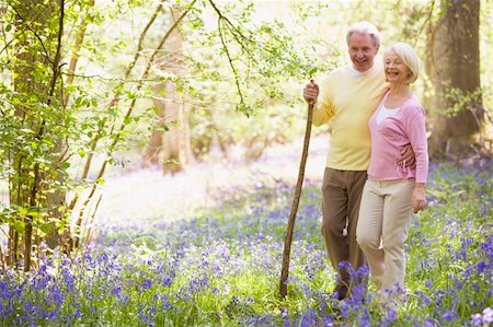 simsearch:862-06676669,k - Couple walking outdoors with walking stick smiling Photographie de stock - Aubaine LD & Abonnement, Code: 400-04045363