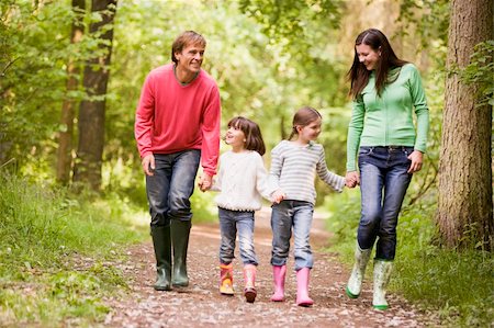 rain boots and child and mom - Family walking on path holding hands smiling Stock Photo - Budget Royalty-Free & Subscription, Code: 400-04045385