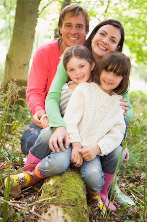 rain boots and child and mom - Family outdoors in woods sitting on log smiling Stock Photo - Budget Royalty-Free & Subscription, Code: 400-04045383