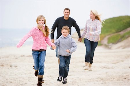 father being chased by kids - Family running at beach holding hands smiling Stock Photo - Budget Royalty-Free & Subscription, Code: 400-04045762