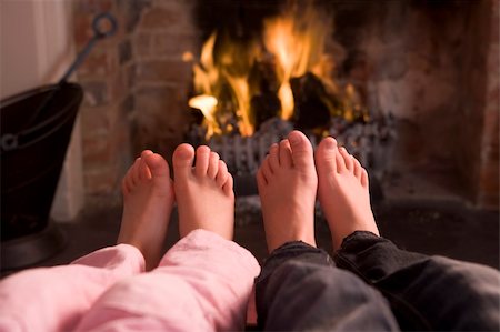 detail of fireplace in the inside of a home - Couple's feet warming at a fireplace Stock Photo - Budget Royalty-Free & Subscription, Code: 400-04045786