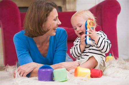 simsearch:400-04045907,k - Mother in living room playing with baby smiling Stock Photo - Budget Royalty-Free & Subscription, Code: 400-04045825