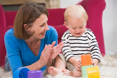 simsearch:400-04045907,k - Mother in living room playing with baby smiling Stock Photo - Budget Royalty-Free & Subscription, Code: 400-04045826