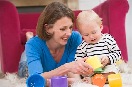 simsearch:400-04045907,k - Mother in living room playing with baby smiling Stock Photo - Budget Royalty-Free & Subscription, Code: 400-04045827
