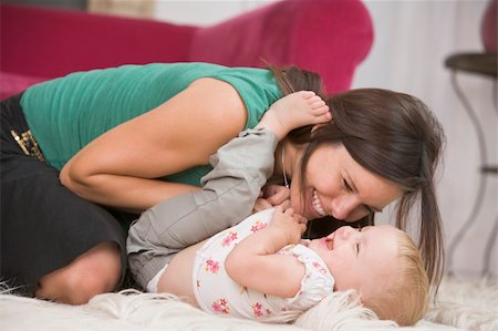simsearch:400-04045907,k - Mother in living room playing with baby smiling Stock Photo - Budget Royalty-Free & Subscription, Code: 400-04045821