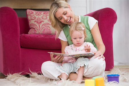 simsearch:400-04045907,k - Mother in living room reading book with baby smiling Stock Photo - Budget Royalty-Free & Subscription, Code: 400-04045823