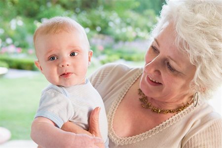 simsearch:400-06205100,k - Grandmother outdoors on patio with baby smiling Stock Photo - Budget Royalty-Free & Subscription, Code: 400-04045854