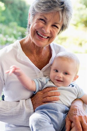 Grandmother outdoors on patio with baby smiling Stock Photo - Budget Royalty-Free & Subscription, Code: 400-04045852