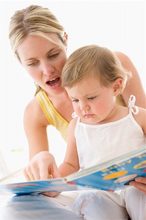 simsearch:400-04045907,k - Mother and baby reading book indoors and pointing Stock Photo - Budget Royalty-Free & Subscription, Code: 400-04045874