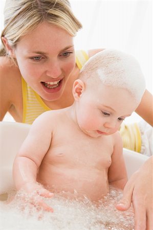 Mother giving baby bubble bath smiling Stock Photo - Budget Royalty-Free & Subscription, Code: 400-04045879