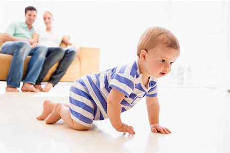 dad crawling - Couple in living room with baby smiling Stock Photo - Budget Royalty-Free & Subscription, Code: 400-04045884
