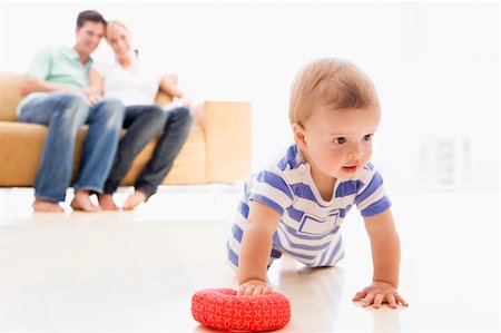 dad crawling - Couple in living room with baby smiling Stock Photo - Budget Royalty-Free & Subscription, Code: 400-04045885