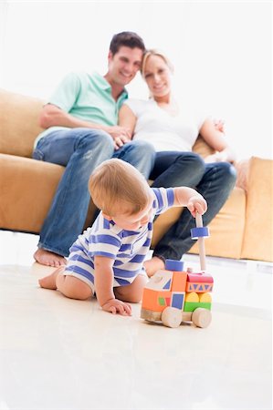 dad crawling - Couple in living room with baby smiling Stock Photo - Budget Royalty-Free & Subscription, Code: 400-04045886