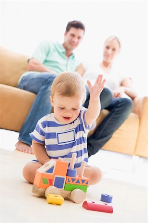 dad crawling - Couple in living room with baby smiling Stock Photo - Budget Royalty-Free & Subscription, Code: 400-04045887