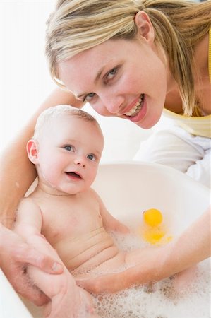 Mother giving baby bubble bath smiling Stock Photo - Budget Royalty-Free & Subscription, Code: 400-04045880