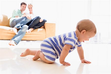 dad crawling - Couple in living room with baby smiling Stock Photo - Budget Royalty-Free & Subscription, Code: 400-04045882
