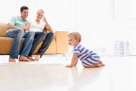 dad crawling - Couple in living room with baby smiling Stock Photo - Budget Royalty-Free & Subscription, Code: 400-04045883